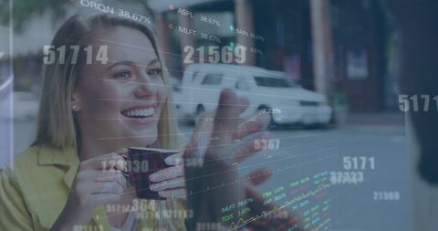 Smiling Woman Enjoying Coffee Amid Digital Financial Graphics Overlay