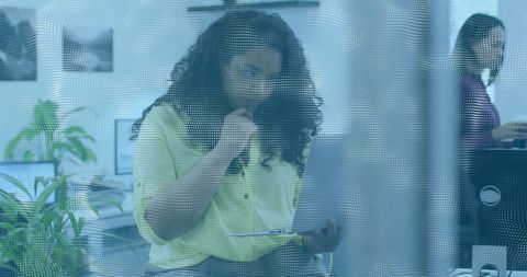 Concentrated woman analyzing reports in modern office setting