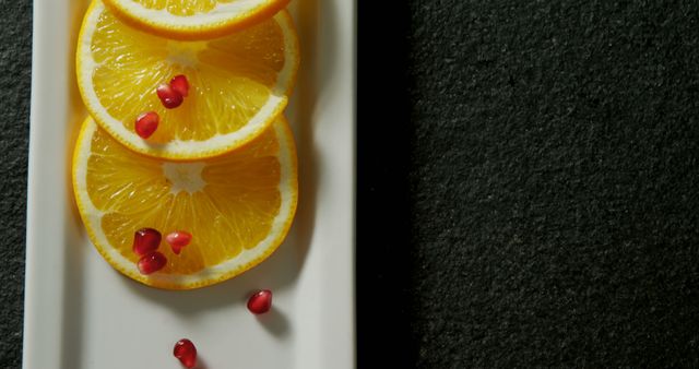Sliced Oranges with Pomegranate Seeds on White Tray - Download Free Stock Images Pikwizard.com