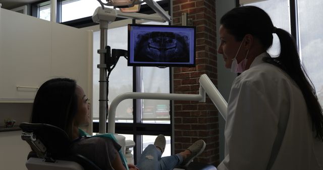 Dentist Examining X-Ray with Patient in Dental Clinic - Download Free Stock Images Pikwizard.com