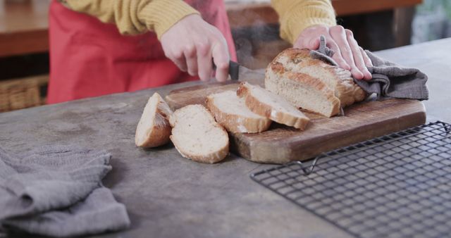 Person Slicing Freshly Baked Rustic Bread in Kitchen - Download Free Stock Images Pikwizard.com
