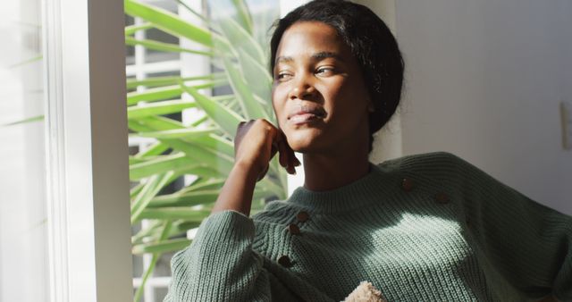 Woman Relaxing by Sunlit Window Looking Thoughtful - Download Free Stock Images Pikwizard.com