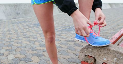 Woman Tying Pink Shoelaces on Blue Running Shoes - Download Free Stock Images Pikwizard.com