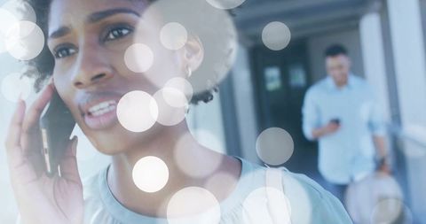 Modern Traveler Communicating through Smartphone at Airport Terminal
