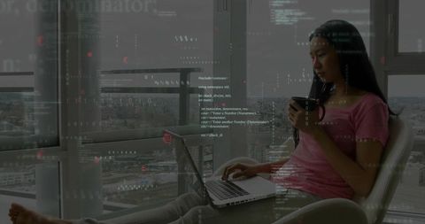 Remote coding and coffee: woman working on laptop in high-rise lounge with skyline view