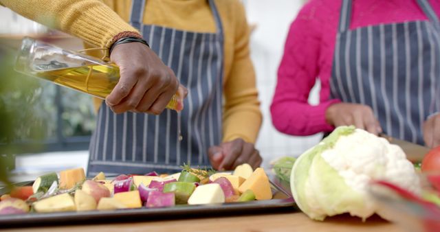 Cooking Vegetables Together in Kitchen Wearing Aprons - Download Free Stock Images Pikwizard.com