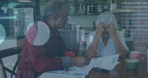 Senior Couple Analyzing Financial Data at Home