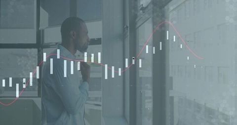 Businessman adjusting tie by window with financial candlestick chart overlay