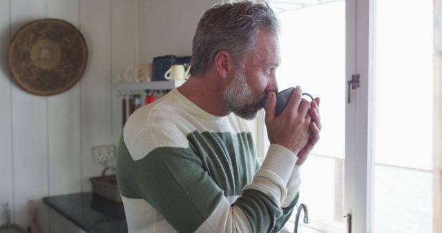 Senior man enjoying morning coffee by the window - Download Free Stock Images Pikwizard.com