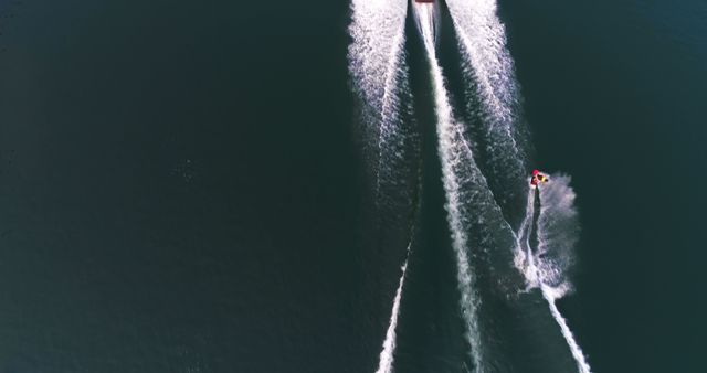 Aerial View of Jet Skier and Speedboat on Open Water - Download Free Stock Images Pikwizard.com