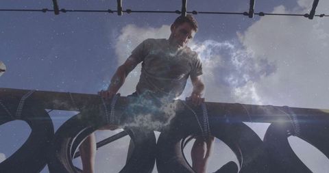 Determined Man Climbing Obstacle Course Highlighting Strength