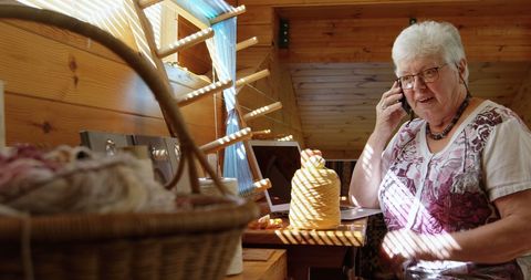 Senior woman enjoying crafting in cozy wooden workshop