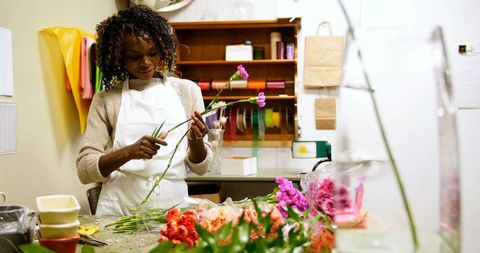 Flower arrangement specialists crafting colorful bouquet