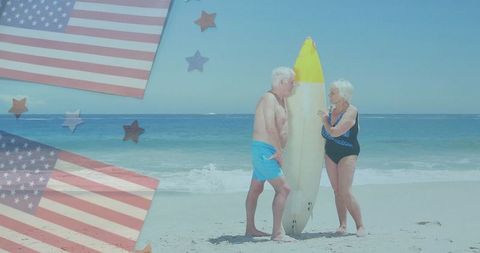 Senior Couple at Beach Holding Surfboard with American Flags