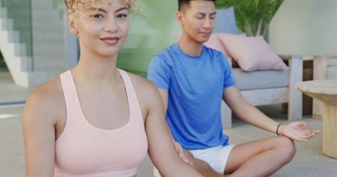 Young couple meditating in relaxing home environment