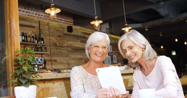 Senior Women Enjoying Time Together in Coffee Shop with Digital Tablet - Download Free Stock Images Pikwizard.com