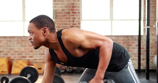 Determined Man Performing Dumbbell Row in Gym - Download Free Stock Images Pikwizard.com