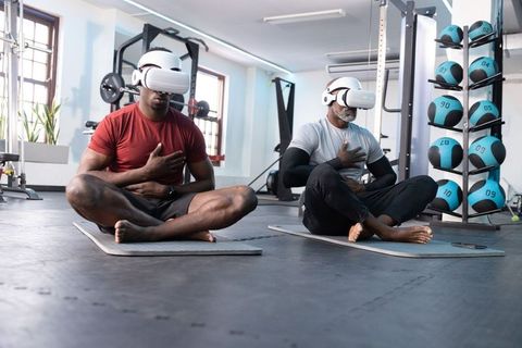 African american men practicing vr mindfulness meditation in contemporary gym