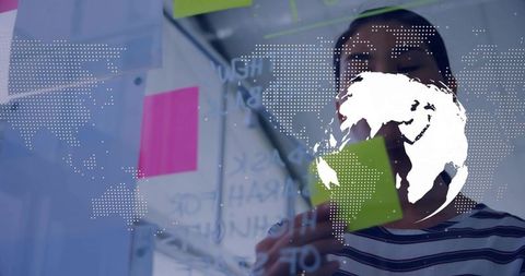 Woman collaborating with sticky notes and digital globe overlay for global strategy