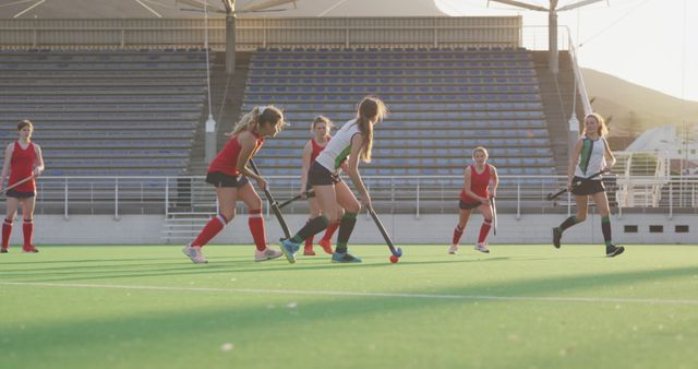 Caucasian female hockey team playing on sunny court - Download Free Stock Photos Pikwizard.com