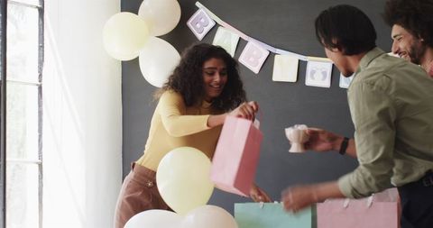 Colleagues preparing office baby shower celebration