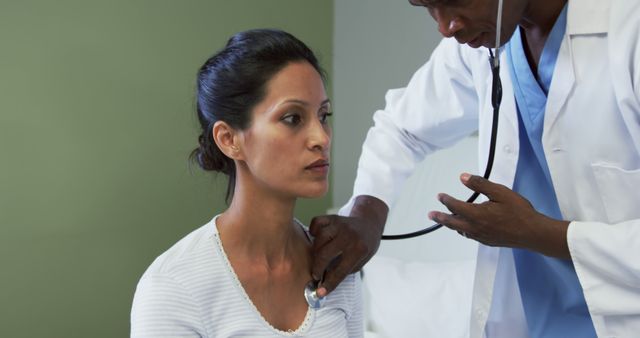 Doctor Examining Female Patient with Stethoscope in Medical Facility - Download Free Stock Images Pikwizard.com