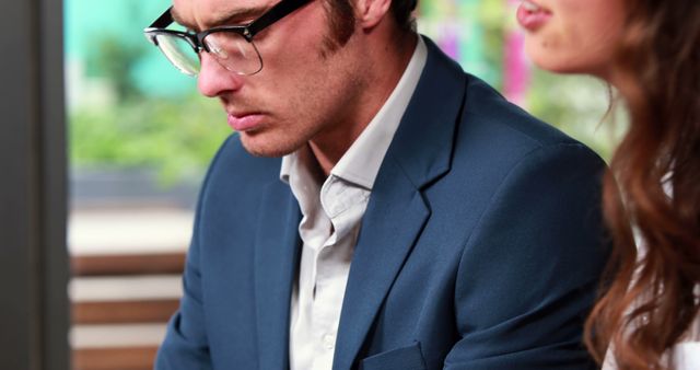 Young Man in Suit and Glasses Working in Office - Download Free Stock Images Pikwizard.com