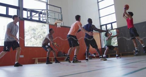 Energetic Group of Young Men Playing Intense Basketball Game