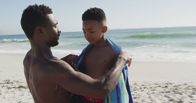 Father Wrapping Son in Towel at Beach on Sunny Day - Download Free Stock Images Pikwizard.com