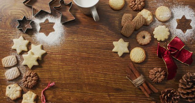 Image of christmas decorations with cookies and copy space on wooden background. christmas, tradition and celebration concept.