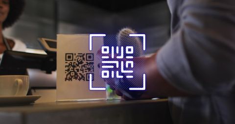 Man paying in cafe with smartwatch and qr code interface