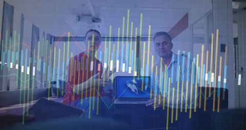 Business Partners Analyzing Digital Financial Graphs on Laptop and Smartphone