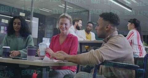 Team Collaboration in Modern Office with Financial Data Overlay