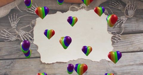 Rustic torn parchment on weathered wood with floating rainbow hearts and skeletal hands