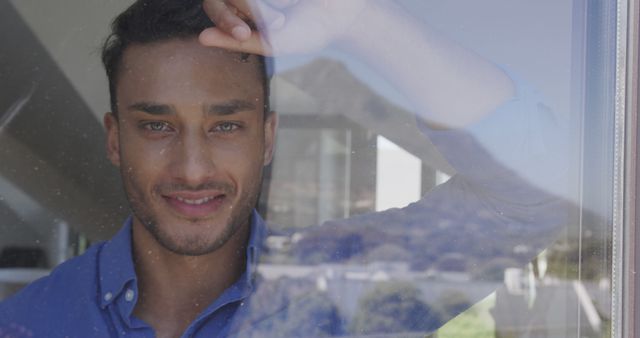 Smiling Man Gazing Through Window on a Sunny Day - Download Free Stock Images Pikwizard.com