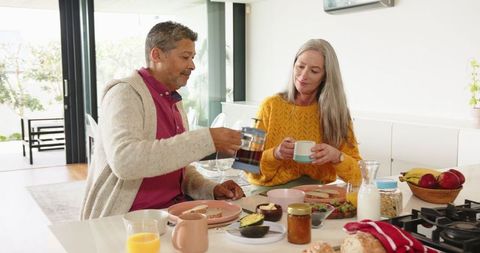 Senior Couple Enjoying Breakfast Together in Modern Kitchen