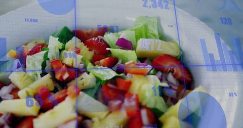 Fresh fruit and greens salad blending with blue data visualization overlay for nutrition
