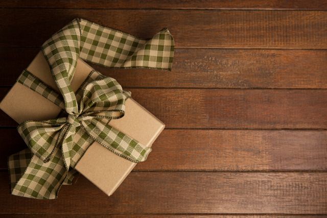 Gift Box with Checkered Ribbon on Wooden Table - Download Free Stock Photos Pikwizard.com