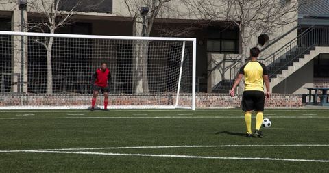 Soccer Player Taking Penalty Kick on Sunny Day