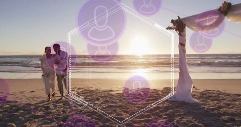 Romantic sunset beach wedding with strolling couple