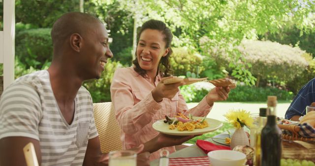 Friends Enjoying Outdoor Meal in Sunny Garden - Download Free Stock Images Pikwizard.com