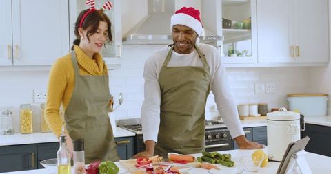 Joyful Couple Enjoying Holiday Cooking Together in Modern Kitchen