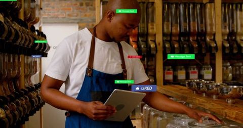 Man in apron handling bulk foods with tablet in rustic store