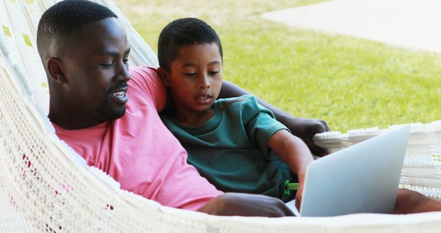 Father and Son Spending Quality Time on Hammock with Laptop Outdoors - Download Free Stock Images Pikwizard.com