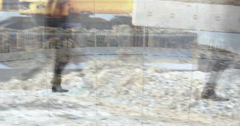 Blurred walkers crossing slushy snowy street, reflections and urban ghosting motion