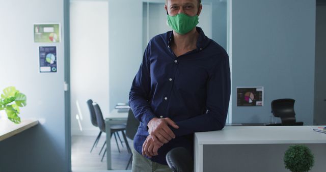 Professional Man Wearing Face Mask Standing in Office Environment - Download Free Stock Images Pikwizard.com