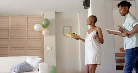 Friends Celebrating with Champagne and Gifts in Modern Home