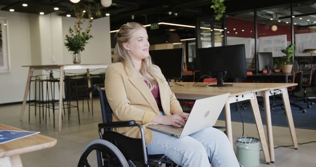 Young Woman in Wheelchair Working on Laptop in Modern Office - Download Free Stock Images Pikwizard.com