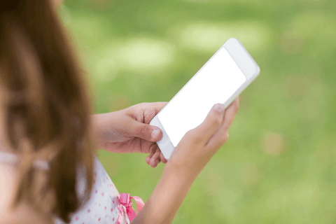 girl holding blank smartphone with transparent background in park - Download Free Stock Videos Pikwizard.com