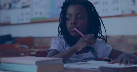 Focused Young Girl Pondering in Classroom with Pencil